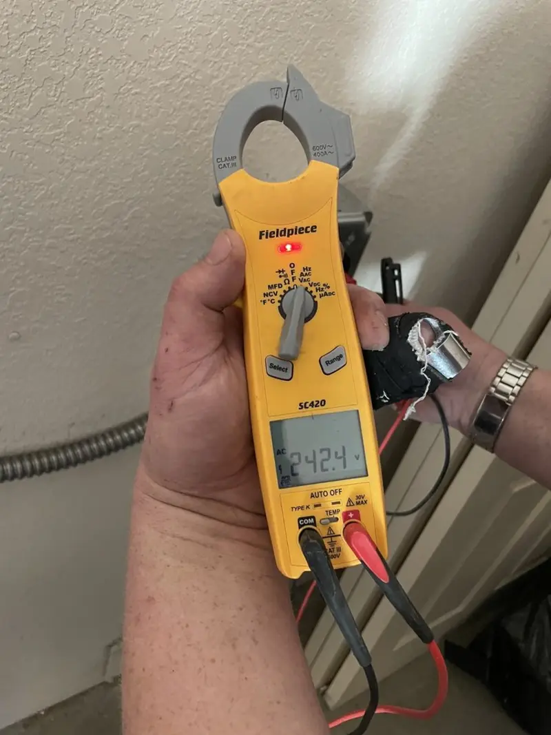 Voltage testing with clamp meter during Recessed Lighting Installation in Filer